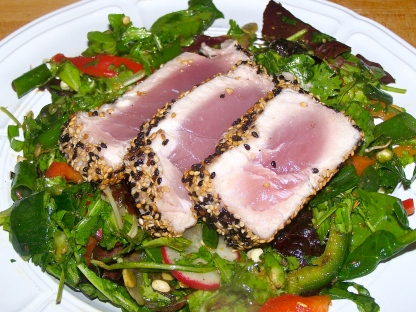 Sesame crusted seared tuna over mixed greens salad